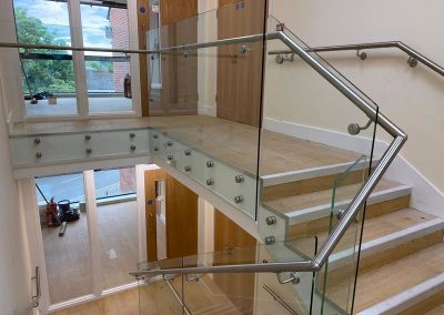 Glass balustrade on landing and staircase in Surrey