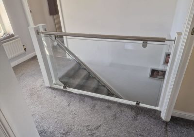 Landing and glass staircase balustrade in residential home
